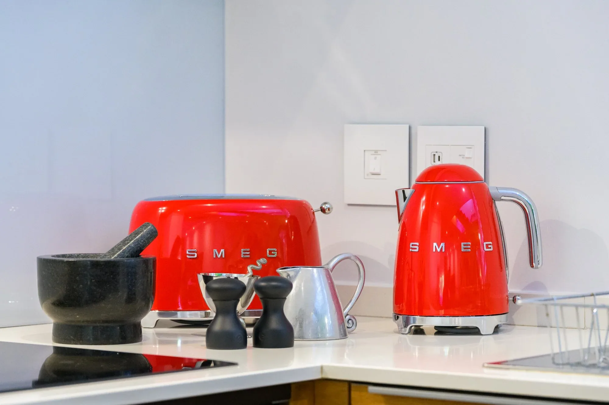 The red kettle and toaster on the counter